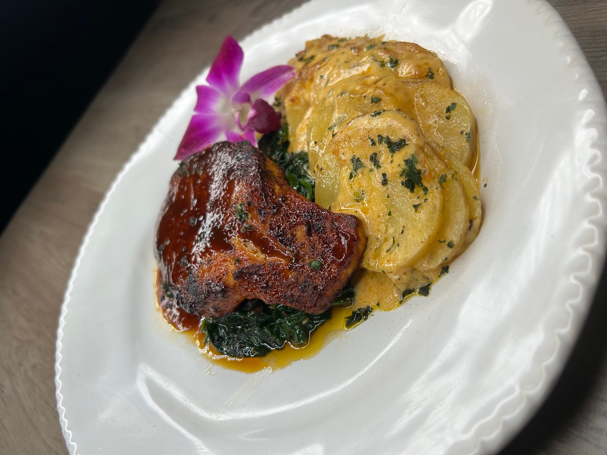 BBQ glazed salmon over potatoes au gratin and spinach